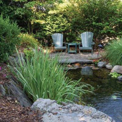 Outdoor Pond with two Patio Chairs